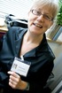Christine laughs at a badge with her ghost picture